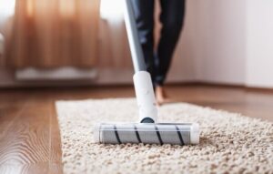 cordless-vacuum-cleaner-cleans-carpet-living-room-with-bottom-legs-modern-technologies-cleaning-house_94046-8292-740x470