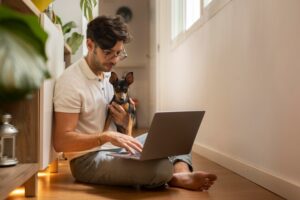 person-working-from-home-with-pet-dog_23-2149104759